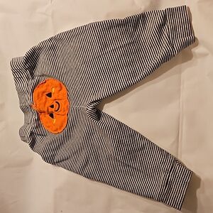 9mos Carters black & white striped leggings with pumpkin on the behind